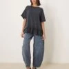 Free People Ruffle Edge Oversized T-shirt Tunic In Washed Black For Women